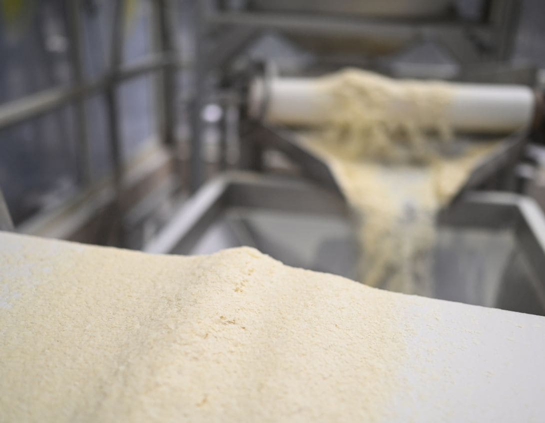 A machine producing a white substance which is potato flour.