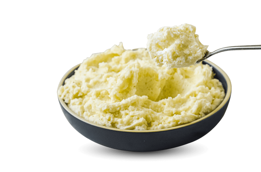 A bowl filled with mashed potatoes, a spoon resting on top.
