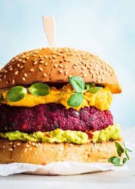 A delectable burger adorned with veggies .