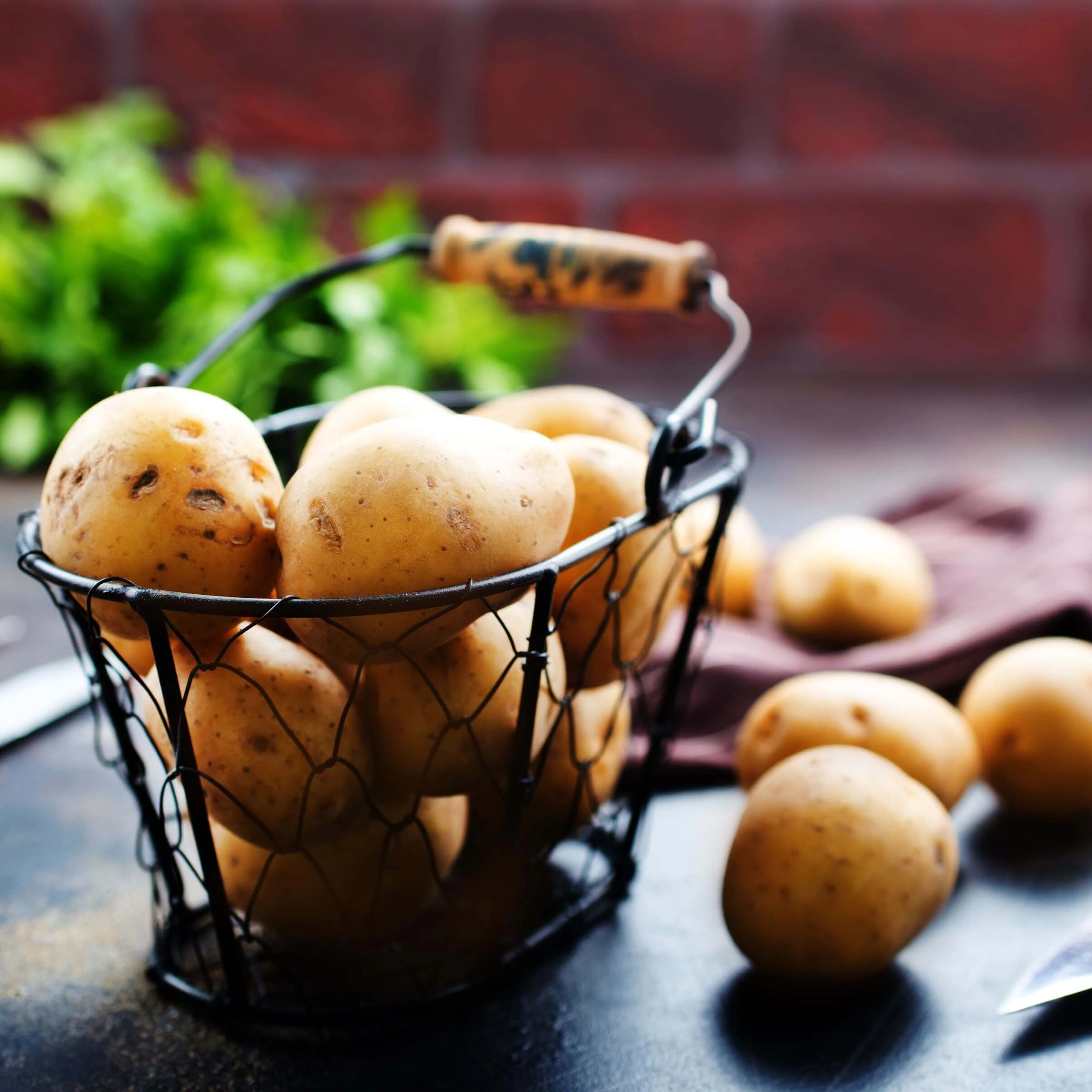 Two bowls filled with chopped up pieces of potato product. 