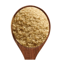  A spoonful of potato granules on a white background .