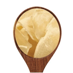  A spoonful of potato slices on a white background .