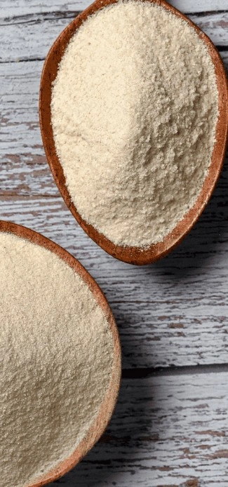 Two bowls of potato flour placed on a wooden table.