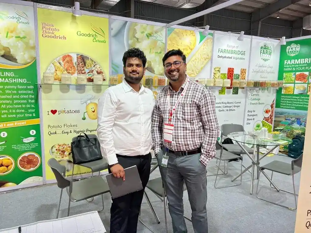 Two men standing together at the Goodrich exhibition at Anuga Mumbai.