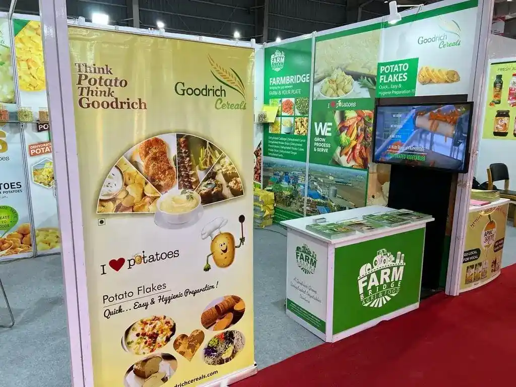 A stand showcasing food products and a television at the Goodrich exhibition Anuga Mumbai.